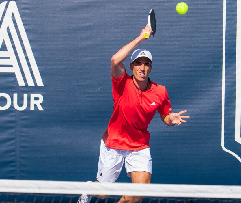 Professional pickleballer Federico Staksrud striking a pickleball.